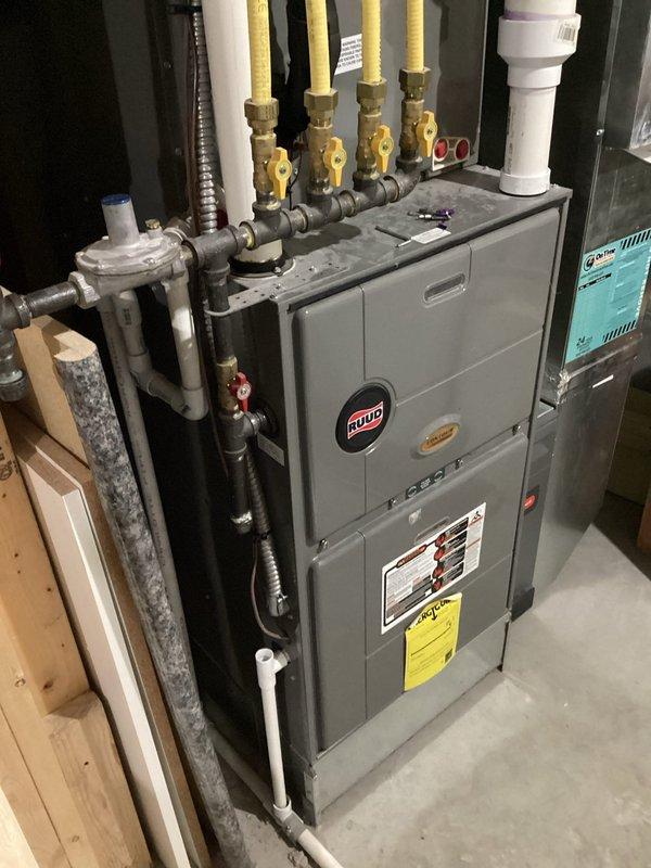 Responded to service call for a Ruud heat pump system exhibiting irregular operation. Diagnostics revealed high amperage draw on compressor, pressure drop, and refrigerant deficiency. System assessment showed proper airflow and clean coils, but compressor was making rough sounds with frequent cycling and unusual startup noise. Customer reported clanking sounds near furnace during system shutdown. Advised customer of repair options; customer elected to operate on emergency heat mode pending final decision on system repair.