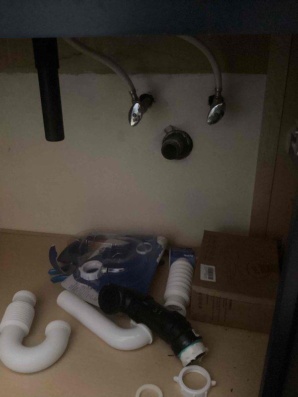 Responded to service call for clogged bathroom sink. Customer had attempted self-repair with snake but was unable to disconnect the trap arm. Upon inspection, removed threaded collar and replaced damaged PVC drain components including P-trap assembly and associated fittings. System now functioning properly with no leaks observed.