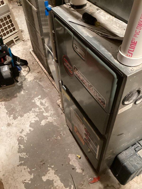 Responded to no heat complaint on 16-year-old Rheem furnace. Diagnosed ignition failure due to severely corroded burners preventing proper flame establishment. Temporarily restored heat functionality through manual intervention. Recommended replacement of rusty burners and noted intermittent squealing from inducer motor that will require future attention. Customer approved burner replacement; parts ordered for follow-up service appointment.