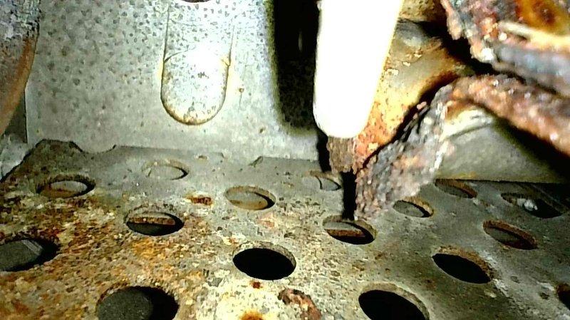 Responded to no heat complaint on 16-year-old Rheem furnace. Diagnosed ignition failure due to severely corroded burners preventing proper flame establishment. Temporarily restored heat functionality through manual intervention. Recommended replacement of rusty burners and noted intermittent squealing from inducer motor that will require future attention. Customer approved burner replacement; parts ordered for follow-up service appointment.