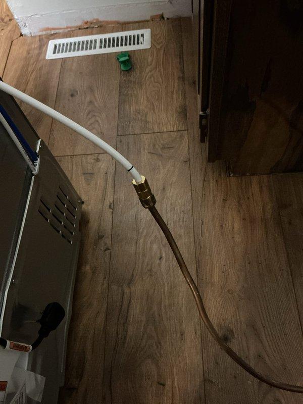 Disconnected water line from old refrigerator and reconnected to new unit. Upon inspection, identified failing saddle valve requiring replacement. Successfully installed new valve assembly and verified proper connection of copper water line to ensure reliable water supply to customer's refrigerator.