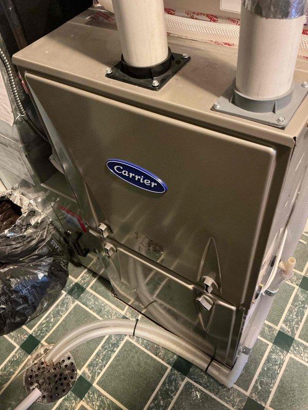 Responded to service call for one-year-old Carrier heat pump system with ecobee thermostat displaying "action required" notification. Diagnosed issue with auxiliary heat running unnecessarily due to improper temperature threshold configuration. Adjusted outdoor temperature setpoint from 70°F to 40°F to enable proper heat pump operation above 40°F, eliminating reliance on auxiliary heat during moderate temperatures. System now functioning correctly with appropriate staging sequence.