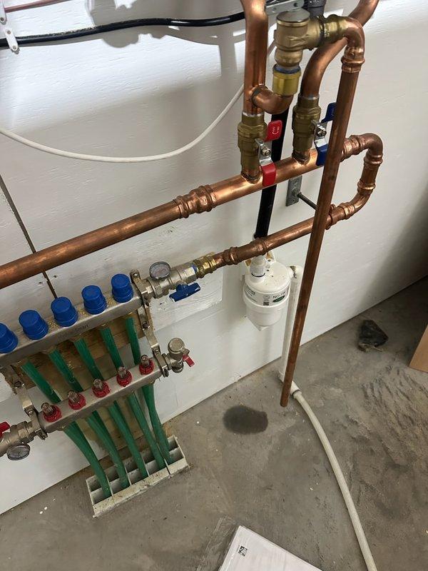 Responded to warranty service call for recently installed boiler (5 months old) exhibiting glycol leak at a pro press fitting on copper pipe. Identified drip at connection point in plumbing network. Operated unit and adjusted temperature settings to manufacturer specifications for in-floor heating system.