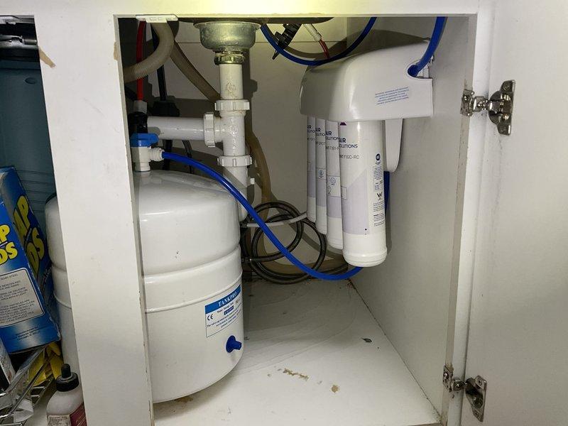 Responded to service call for leaking reverse osmosis water filtration system under kitchen sink. Diagnosed issue with leaking 3/8" Female x 3/8" Push fittings at faucet connection. Resolved by installing 1/4" tubing with compression nut to faucet and installing 1/4" x 3/8" push fitting to RO system. System tested successfully with no leaks.