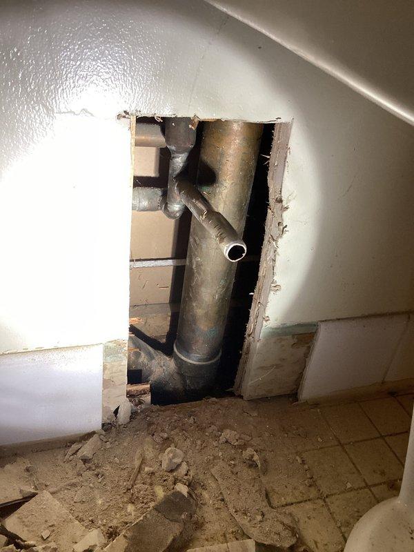 Accessed plumbing through wall cutout in modular home to replace toilet shutoff valves with chrome sleeve in upstairs bathroom. Installed new stops and supply tubes for main floor toilet and bath sink (copper tubing), along with new trip levers for both main floor and lower level toilets which customer had previously attempted to replace unsuccessfully.