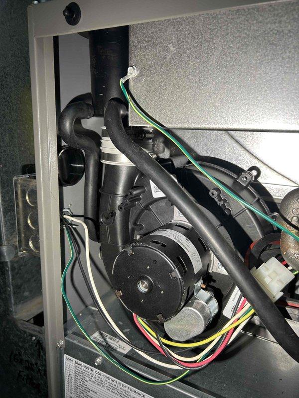 Performed comprehensive furnace tune-up service including correction of gas train pressure from 3.671 inWC to 3.30 inWC and clearing of condensate drain line and trap that contained accumulated spiderwebbing and debris. Verified proper operation of all critical components (inducer motor, capacitor, pressure switch, control board connections, and thermostat), confirmed moderate condition of return air filter, and documented combustion CO at 18 ppm, with furnace now operating normally with no immediate concerns.