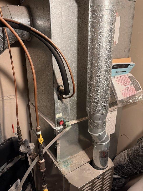 Repaired a 16-year-old Carrier Performance furnace that was running but not providing heat. Diagnosed issues with a burned flame sensor wire and excessive dust buildup causing potential flame rollout. Service included resplicing the damaged wire and performing a thorough cleaning of all furnace compartments to restore proper heating function.