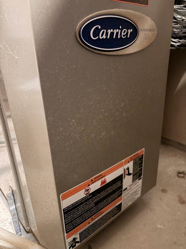 Repaired a 16-year-old Carrier Performance furnace that was running but not providing heat. Diagnosed issues with a burned flame sensor wire and excessive dust buildup causing potential flame rollout. Service included resplicing the damaged wire and performing a thorough cleaning of all furnace compartments to restore proper heating function.