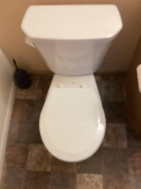 Replaced cracked toilet tank with new standard height toilet installation. Completed full toilet assembly including new wax ring and mounting bolts, ensuring proper seal and secure fixture attachment.