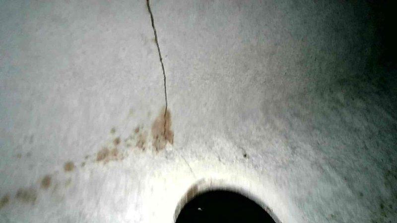 Responded to no heat service call for vacant property with a Comfort Maker forced air furnace. Diagnosed inducer motor running continuously due to stuck open pressure switch. After clearing the switch, performed heat exchanger inspection which revealed significant cracking in primary cell. Equipment was tagged out of service due to safety hazard. Communicated findings to property contact and discussed options for heat exchanger replacement versus full system replacement.