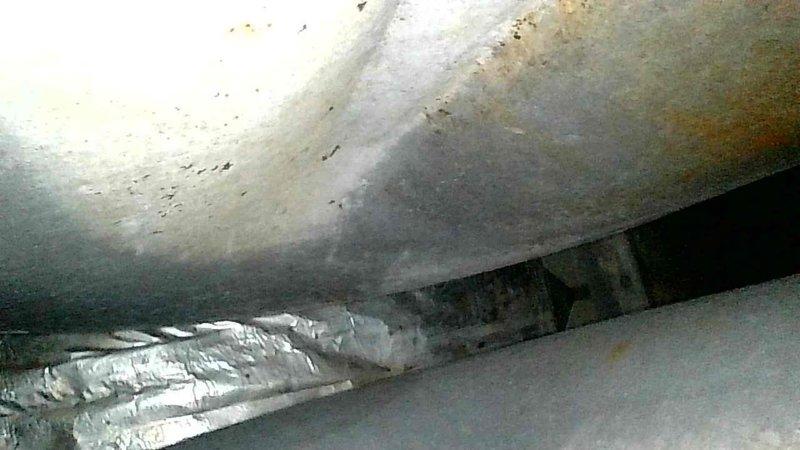 Diagnosed and condemned furnace due to cracked heat exchanger discovered during no-heat service call. Visual inspection revealed significant corrosion and oxidation inside heat exchanger. Unit was tagged out of service and recommended replacement due to advanced age of system and safety concerns.