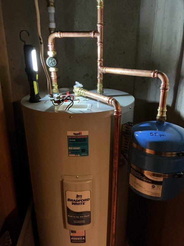 Diagnosed recently installed Bradford White water heater reporting no hot water. Found insufficient voltage supply (99V) to unit despite presence of intact fuse at peak time box. Multiple reset attempts unsuccessful. Electrical issue identified beyond plumbing scope - customer advised to contact electrician for proper voltage restoration to water heater circuit.