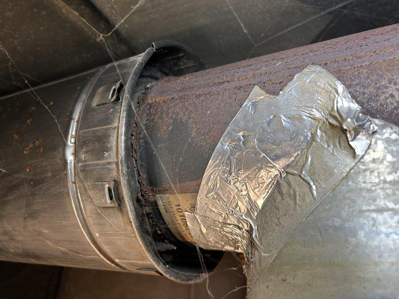 Responded to no-heat call for an aging oil furnace in barn office. Diagnosed intermittent ignition failure; manipulated primary control which resolved the issue temporarily. System eventually fired up and cycled properly through multiple thermostat tests. Inspection revealed severely rusted flue pipe with significant holes due to environmental exposure. Heat exchanger appeared intact without visible cracks. Recommended replacement of primary control, complete oil tune-up service, and replacement of deteriorated flue pipe components.