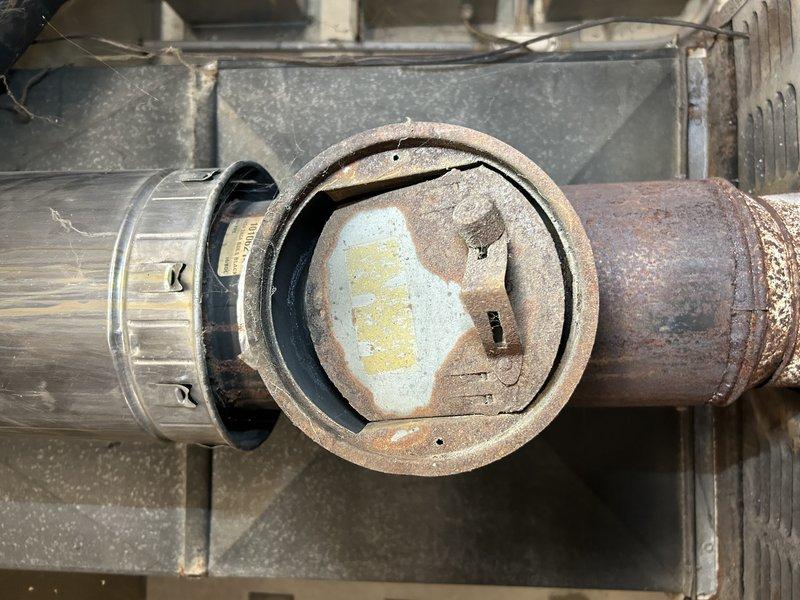 Responded to no-heat call for an aging oil furnace in barn office. Diagnosed intermittent ignition failure; manipulated primary control which resolved the issue temporarily. System eventually fired up and cycled properly through multiple thermostat tests. Inspection revealed severely rusted flue pipe with significant holes due to environmental exposure. Heat exchanger appeared intact without visible cracks. Recommended replacement of primary control, complete oil tune-up service, and replacement of deteriorated flue pipe components.