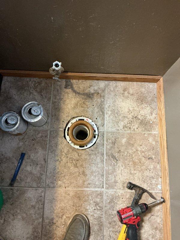 Removed and replaced customer-supplied toilet. Upon removal, discovered closet flange positioned approximately one inch below floor level. Modified and reinstalled closet flange to proper height before mounting new toilet fixture to ensure secure installation and prevent potential leaks.