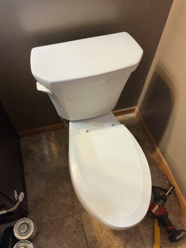 Removed and replaced customer-supplied toilet. Upon removal, discovered closet flange positioned approximately one inch below floor level. Modified and reinstalled closet flange to proper height before mounting new toilet fixture to ensure secure installation and prevent potential leaks.