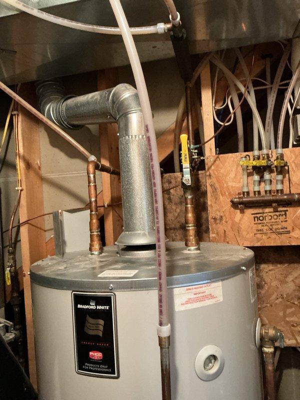 Diagnosed water heater showing no hot water with five-blink error code indicating thermostat fault. Performed maintenance on Bradford White unit by cleaning burner assembly and thermal couple. System operated temporarily before error code reappeared, suggesting potential thermostat or sensor issue requiring further attention.