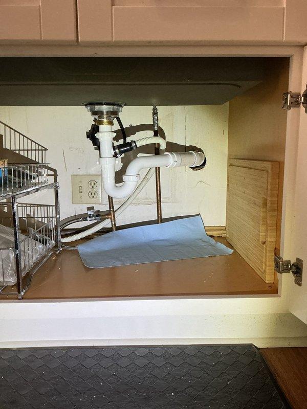 Responded to customer complaint of garbage disposal leaking from disposal unit with drain positioned too high. Removed faulty garbage disposal, installed new drain basket and outlet tee to correct drainage configuration. Completed installation of updated plumbing assembly with proper P-trap configuration to ensure proper function and eliminate leakage.