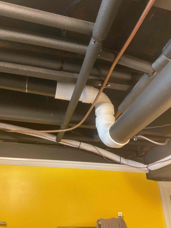 Responded to warranty service call regarding water leakage from recently installed exhaust system. Performed inspection of the exhaust piping in ceiling area, identifying improper drainage at elbow joint connections. Corrected issue by reinstalling affected PVC section with proper primer/cement application and ensuring appropriate pitch for condensate drainage.