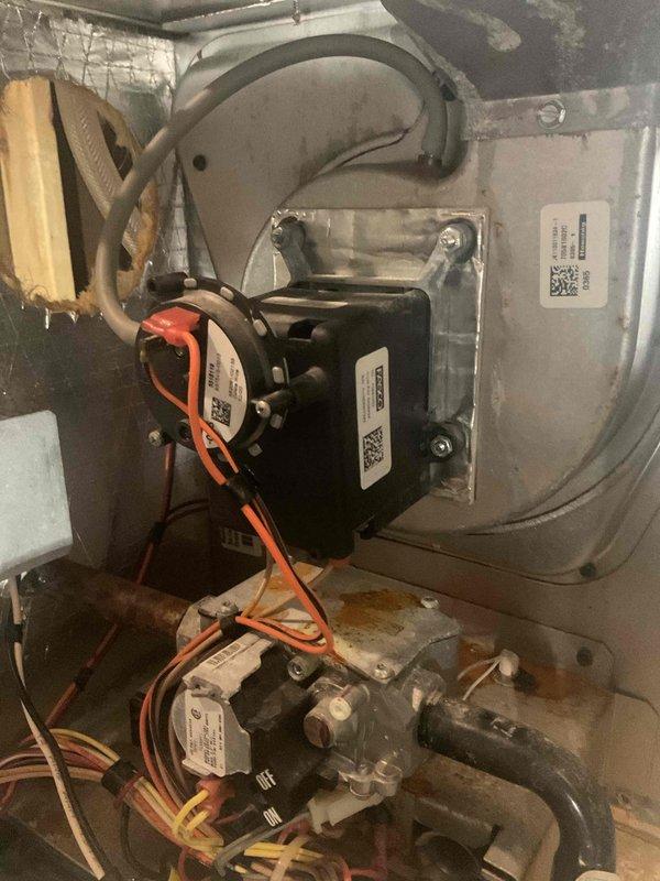 Responded to no heat call for furnace operating 12° below setpoint. Diagnostic testing revealed failed inducer motor with visible corrosion and rust formation on internal components. Successfully replaced inducer motor assembly, restoring proper system operation and heat production.