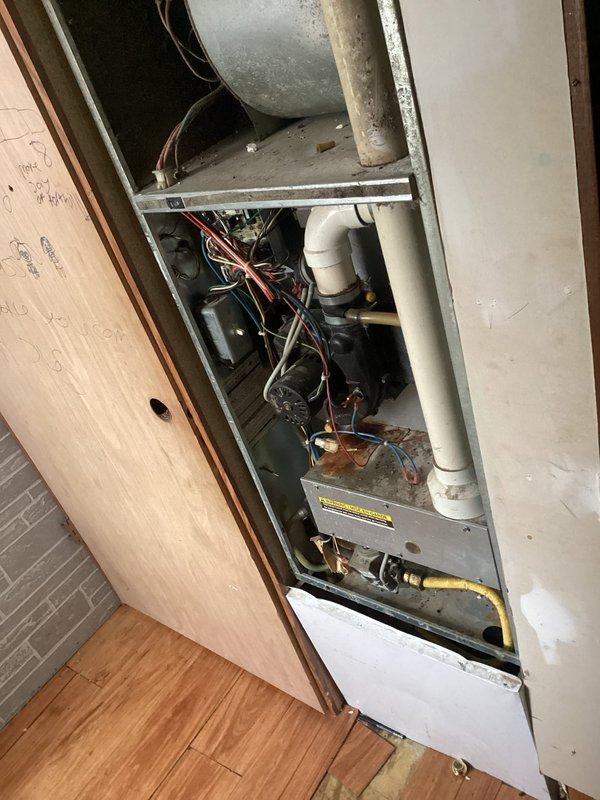 Responded to no heat complaint on older mobile home furnace. Diagnosed water accumulation in inducer motor due to plugged condensate line. Drained approximately 2 cups of water from collector box and cleaned trap to restore proper drainage. Noted significant bearing play and dirt accumulation in blower motor. After clearing condensate and cycling power, furnace operated normally for 20 minute test period. Heat exchanger inspection revealed no compromises. Customer advised to schedule evaluation for potential replacement options due to unit's age and condition.