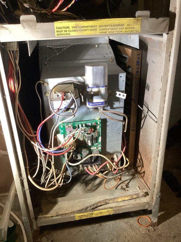 Responded to no heat complaint where furnace was short-cycling and struggling to maintain temperature. Diagnosed flame sensing issue and performed flame sensor cleaning. Further inspection revealed a cracked heat exchanger with debris on secondary heat exchanger and a compromised burner inlet. Also identified defective blower capacitor (reading 10μF instead of rated 12.5μF) and worn blower motor bearings. Tagged unit as unsafe due to heat exchanger failure and scheduled follow-up consultation for replacement options.