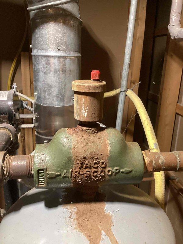 Responded to call for a 12-4 NG boiler system (10+ years old) not providing heat. Diagnosed low water pressure and stagnant circulation. Flushed system to remove significant discoloration and air pockets, restoring proper water flow and system operation. Identified leaking air eliminator as root cause; recommended replacement to prevent recurrence.