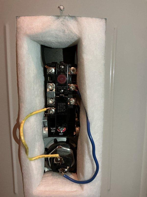 Responded to warranty service call for recently installed water heater not producing adequate hot water. Diagnosed system operating at only 105°F. Adjusted thermostat settings to increase temperature to 122°F, confirming proper operation with electrical testing equipment.