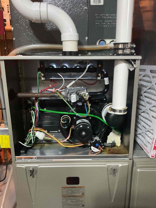 Completed exhaust system repairs on residential furnace involving replacement of 2-inch PVC venting components. Installed new exhaust mounting bracket flange at furnace connection point and reconstructed PVC exhaust piping with proper connections. Total repair time: 2 hours.