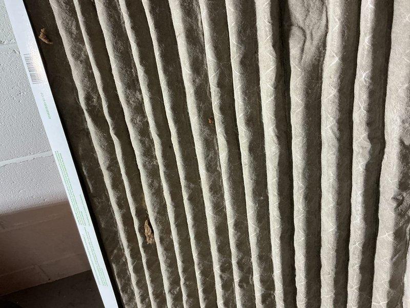 Responded to water leak complaint near water heater. Diagnosed issue as condensation problem caused by clogged HVAC filter, not an actual plumbing leak. Filter was heavily soiled with dust and debris. Advised customer to replace filter to prevent future condensation issues.