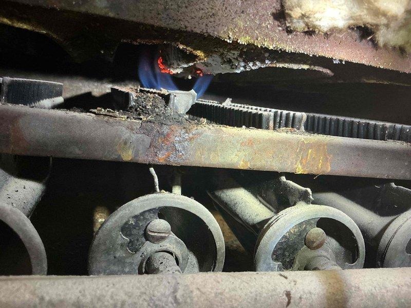 Responded to second opinion service call for a 1960 boiler with reported CO leak. Upon inspection, confirmed presence of carbon monoxide leaking from boiler jacket and high CO emissions through chimney. Visual examination revealed significant oxidation and deterioration of metal components with flame improperly burning in confined space, validating previous technician's safety concerns. Unit requires replacement due to age and safety hazards.