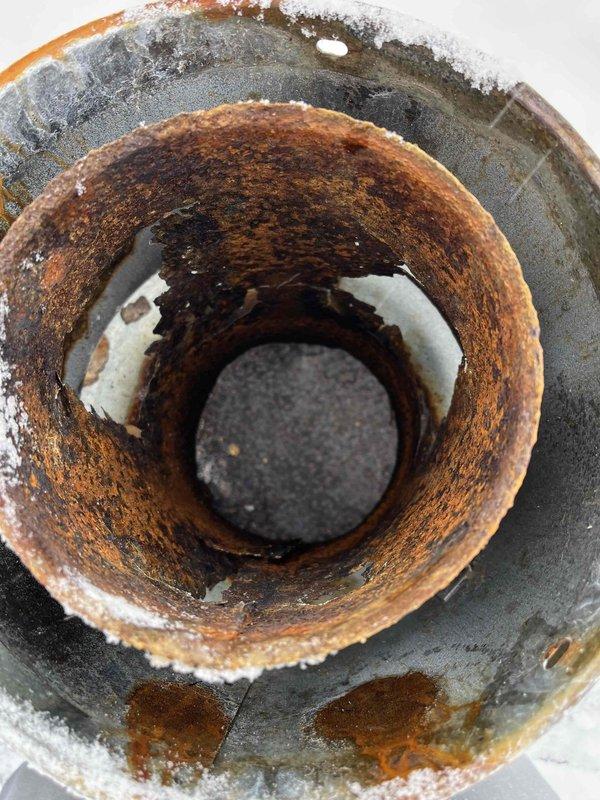 Diagnosed a 5-6 year old furnace with insufficient heating due to a weak flame code. Investigation revealed a completely rusted out roof jack on the exhaust and intake, causing the furnace to draw in exhaust fumes. Temporarily cleared ice buildup around intake, but determined the severely corroded component requires replacement to restore proper combustion and heating function.