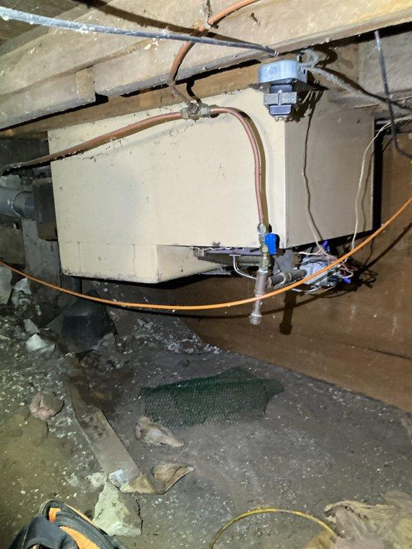Responded to no heat call for 30-40 year old LP radiant furnace. Diagnosed multiple critical safety issues including unlit pilot light, corroded thermocouple, holes in the exhaust collector box, and improperly secured gas burner tube (wired on). Recommended full system replacement through comfort advisor due to age and extensive deterioration of critical components.