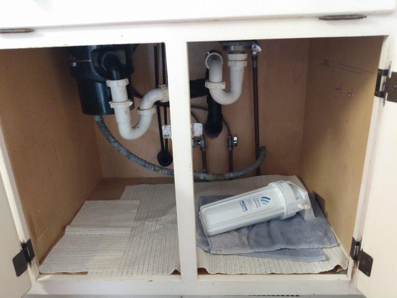 Diagnosed kitchen sink plumbing issue and identified non-functional hot water shut-off valve. Upon inspection of under-cabinet plumbing components, confirmed valve failure on hot water side requiring replacement. Provided customer with estimate for complete valve replacement service.