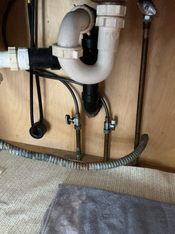 Diagnosed kitchen sink plumbing issue and identified non-functional hot water shut-off valve. Upon inspection of under-cabinet plumbing components, confirmed valve failure on hot water side requiring replacement. Provided customer with estimate for complete valve replacement service.