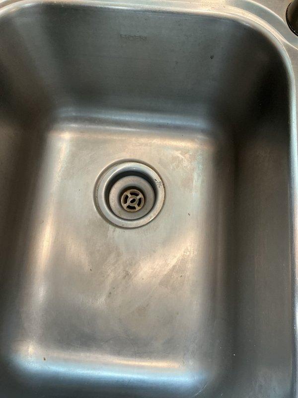 Responded to service call for leaking sink with worsening condition after customer attempted repair. Inspection revealed broken basket strainer causing leak at sink drain connection. Removed damaged component and installed new basket strainer to restore proper seal and eliminate under-sink water leakage.
