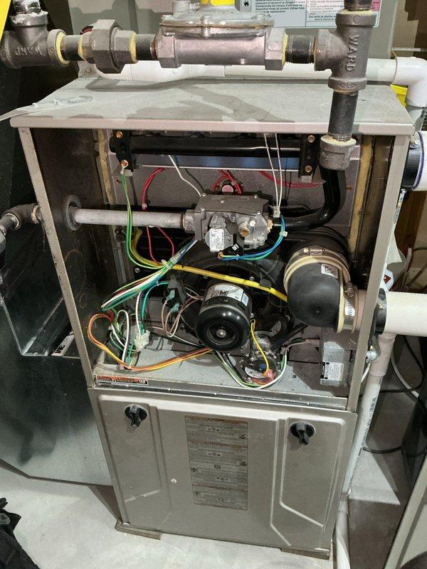 Responded to service call for 6-year-old furnace with heating performance issues and non-functional humidifier. Inspection revealed dirty filter restricting airflow, contaminated blower wheel, and failing gas valve - all contributing to system's inability to maintain temperature. Removed and replaced filter, cleaned components, and documented control board status via diagnostic photos for follow-up repair recommendation.