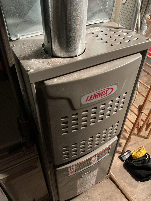 Responded to customer concern about overheating 1980s Lennox gas furnace with suspected exhaust flue leakage. Inspection revealed no leakage, only normal rust accumulation on the flue pipe. Conducted electrical testing with EM152 meter, measuring 347V. Performed minor gas pressure adjustment to optimize furnace operation and reduce overheating issue.