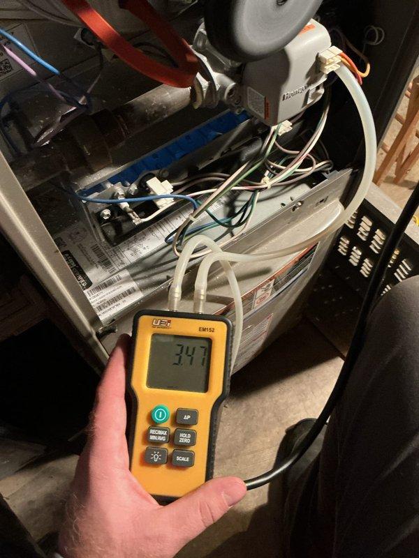 Responded to customer concern about overheating 1980s Lennox gas furnace with suspected exhaust flue leakage. Inspection revealed no leakage, only normal rust accumulation on the flue pipe. Conducted electrical testing with EM152 meter, measuring 347V. Performed minor gas pressure adjustment to optimize furnace operation and reduce overheating issue.