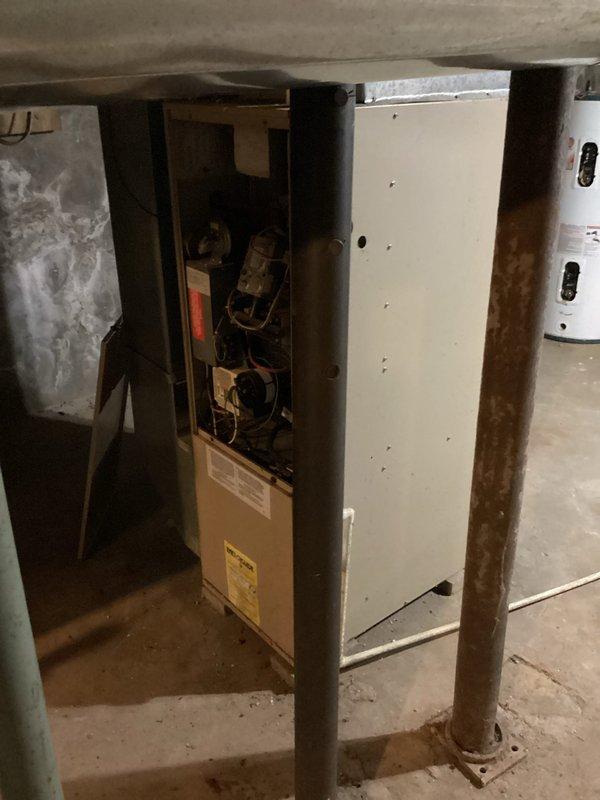 Responded to no heat complaint at rental property with older furnace system (exact age unknown). Upon diagnostic inspection, determined the blower motor had failed - evidenced by loud operational noise despite presence of flames. Recommended replacement of the motor and scheduled follow-up estimate for potential complete system replacement due to age of both units in property.