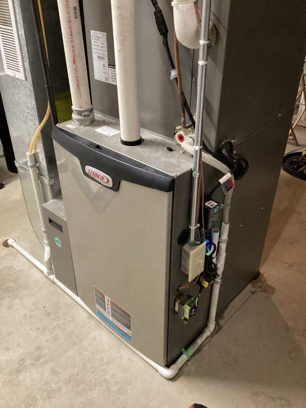 Responded to service call for 4-year-old Lennox furnace with water leakage. Determined water was coming from secondary heat exchanger due to improper leveling during initial installation. Completed furnace tune-up including cleaning flame sensor, checking condensate drainage, inspecting heat exchanger, air filter, and electrical components - all within specifications. Re-leveled the furnace to resolve leakage issue and informed customer about warranty coverage.