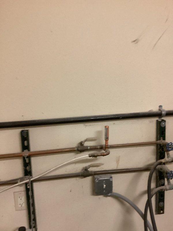 Inspected property regarding non-compliance issues cited by city inspector, specifically concerning a water tea installation for soap dispenser functionality and AVB compliance. Took photographic documentation of the copper piping installation and plumbing fixtures, then communicated directly with the inspector by sharing these images. Inspector confirmed the installation now meets code requirements and will return in approximately 20 days for final verification.