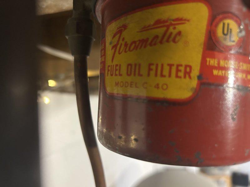 Responded to customer report of loud popping noise from oil furnace during initial startup. Inspection revealed barometric damper had detached from exhaust pipe. Diagnosed overheating condition due to clogged air filter and debris buildup on blower wheel. Recommended oil tuneup service, cleaning of blower wheel, and replacement of vintage Firomatic Fuel Oil Filter housing (Model C 40) as needed. Scheduled follow-up service advisor appointment.