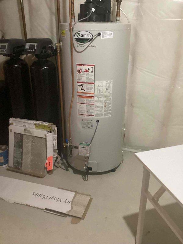 Responded to service call for an A.O. Smith tanked water heater approximately 30 years old with no hot water. Diagnostic assessment revealed unit was leaking and in lockout mode with pilot light failure. Provided customer with replacement options due to age and condition of unit.