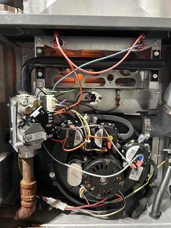 Performed comprehensive furnace tune-up on FRP system of unknown age. Cleared condensate drain line and trap of accumulated debris and spiderwebs, recorded combustion CO at 9 ppm, and verified proper operation of all critical components (inducer motor, capacitor, pressure switch, control board connections, and thermostat). System is functioning normally with no immediate concerns; return air filter in moderate condition.