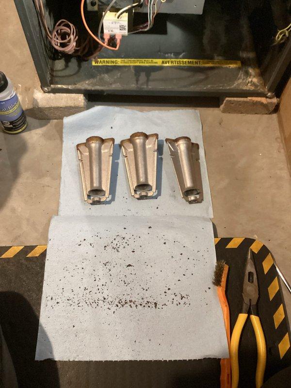 Responded to a no-heat call for a 6-7 year old Goodman LP forced air furnace displaying lockout code. Diagnostic testing revealed the furnace was attempting ignition (igniter lighting and gas valve opening) but failing to sustain operation due to excessive start retries. Inspection identified severely corroded and plugged burners as the primary issue. Heat exchanger was thoroughly examined with no compromises found. Performed immediate service by removing and cleaning burners to restore temporary heat. System tested successfully with 40° temperature rise and operated normally for 15 minutes without issues. Recommended replacement burners (to be ordered) due to extensive corrosion, and provided customer with estimate for this future service.