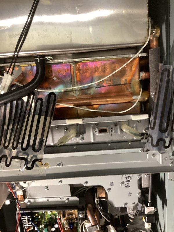 Responded to service call for a Richmond tankless water heater displaying Error 12 and Error 14 codes. Diagnostic inspection revealed system not operating with heat exchanger overheating issues. Performed comprehensive troubleshooting of igniter, flame sensors, condensate trap/line, control board, and wiring connections. Determined ignitor failure and evidence of scaling in heat exchanger. Ordered necessary replacement parts and recommended descaling service to restore proper operation.