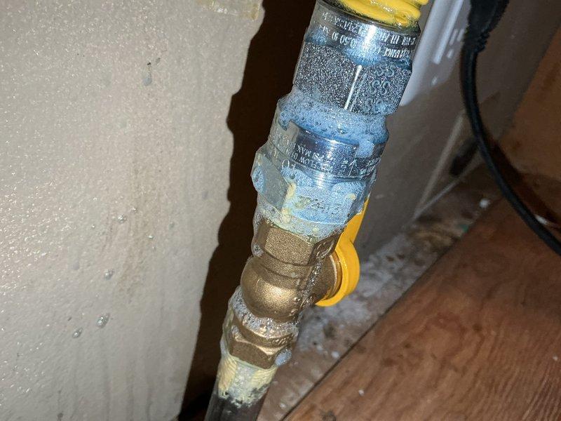 Responded to a follow-up service call regarding suspected gas leak. Performed comprehensive inspection of gas supply line behind stove, noting significant corrosion and mineral buildup on pipe fittings and valves. No active gas leak was detected in the supply plumbing; determined issue likely originates from the stove appliance itself.