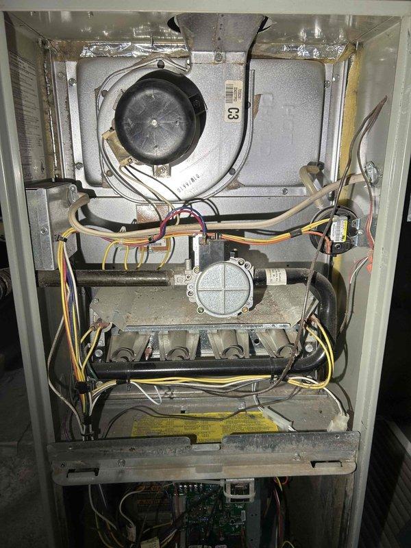 Performed diagnostic inspection on non-operational Trane furnace (2005). Identified two critical issues: gas valve was stuck closed/faulty and confirmed heat exchanger has developed a crack (visible corrosion along seam). Informed homeowner that unit requires either complete furnace replacement or heat exchanger replacement to restore proper operation and ensure safety.