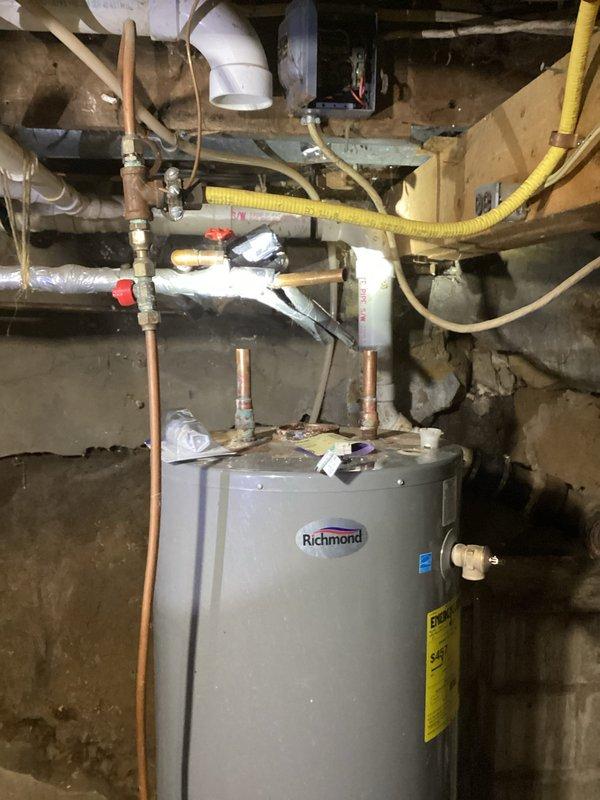Responded to no hot water complaint at customer residence. Upon inspection, found water heater with corroded copper piping and faulty gas valve previously identified in November service call. Completed installation of new electric water heater with proper electrical connections, replacing the deteriorated tank system.